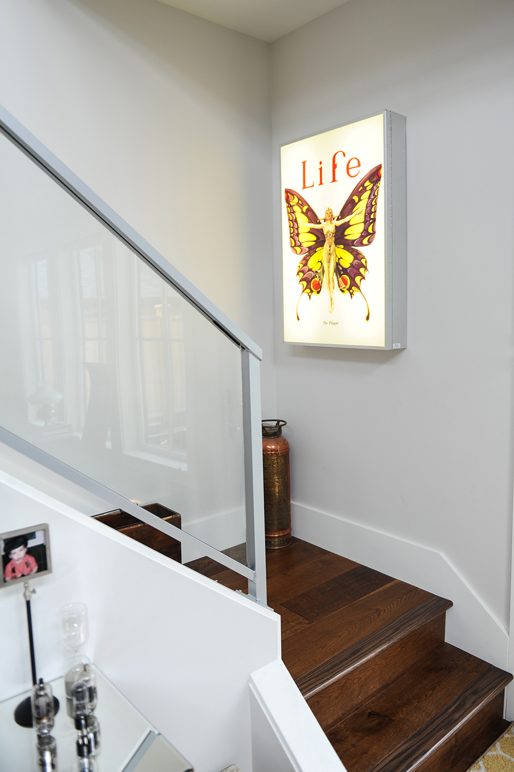 The light box above the stairs is an unlikely homage.