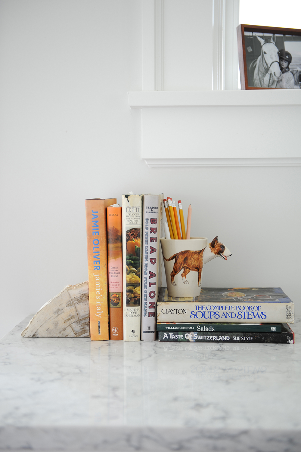 A quirky kitchen vignette featuring old cookbooks.