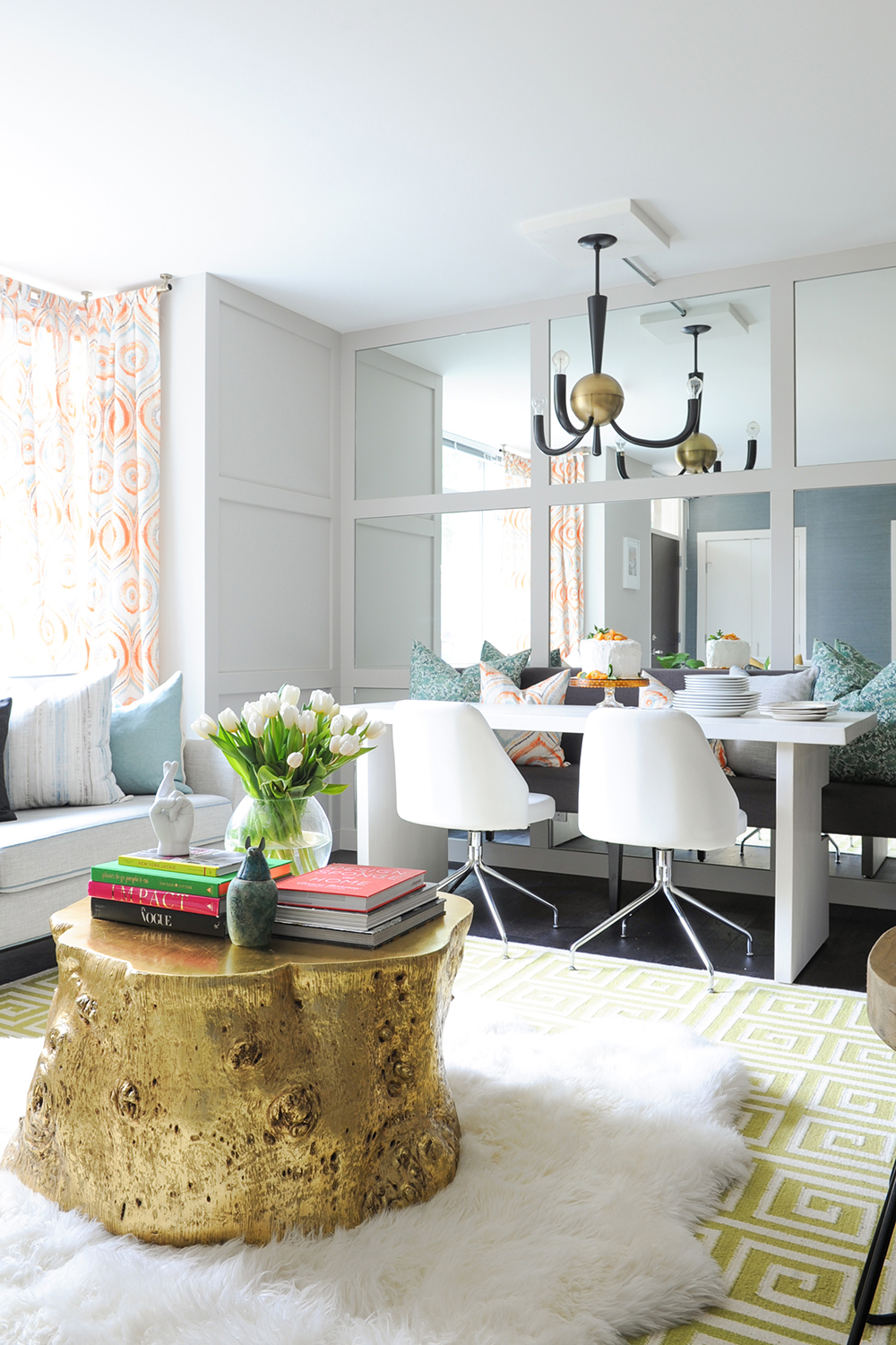 A dining room feature wall crafted from mirrors and stylish panelling.