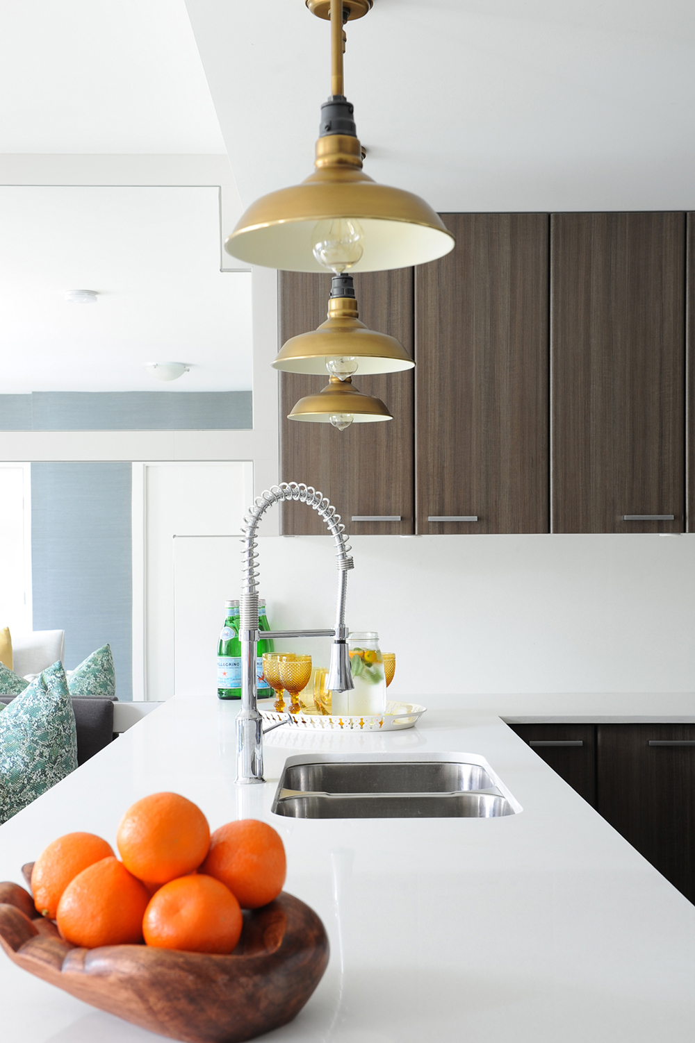 An eclectic kitchen with industrial-style light fixtures.