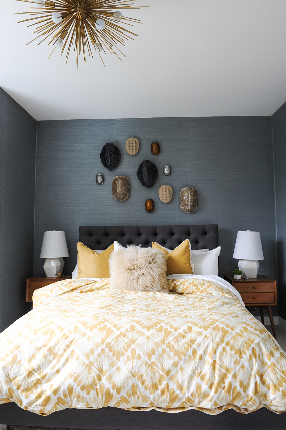 A dark and moody master bedroom uplifted with bright mustard hues.