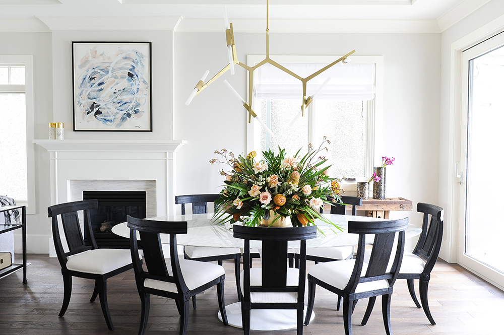 A black and white dining table uplifted with fresh blooms.