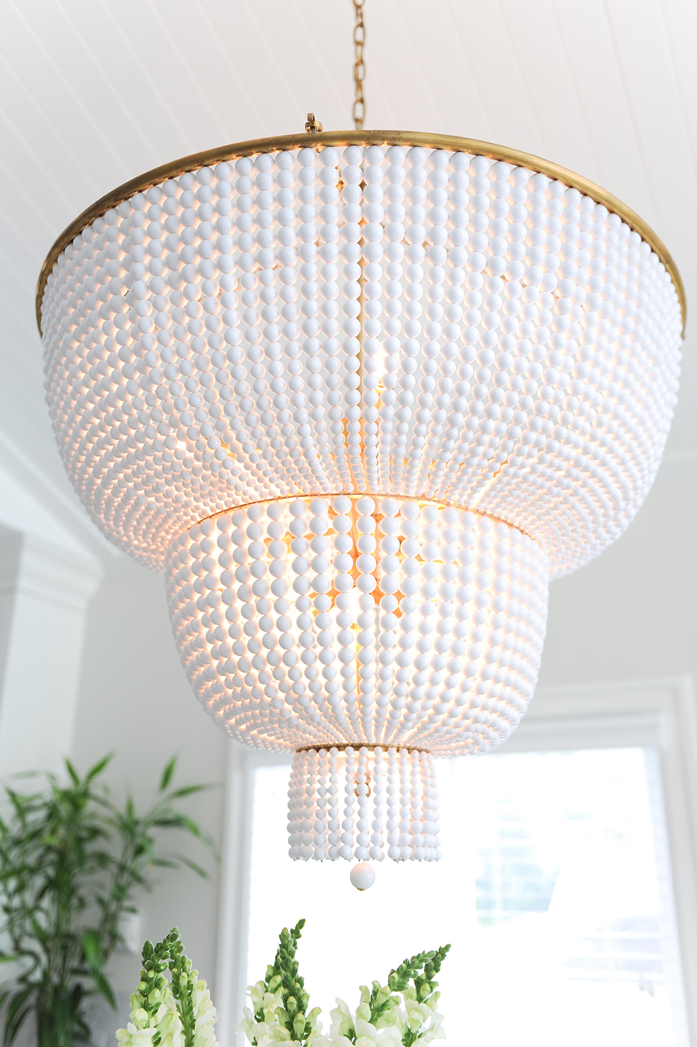 Two-tier chandelier with glass beads set on an antique frame.