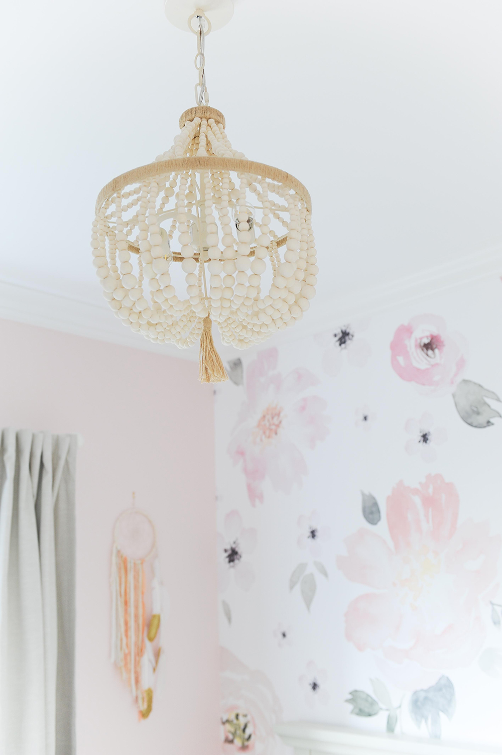 A beaded chandelier acts as a mobile over the crib.