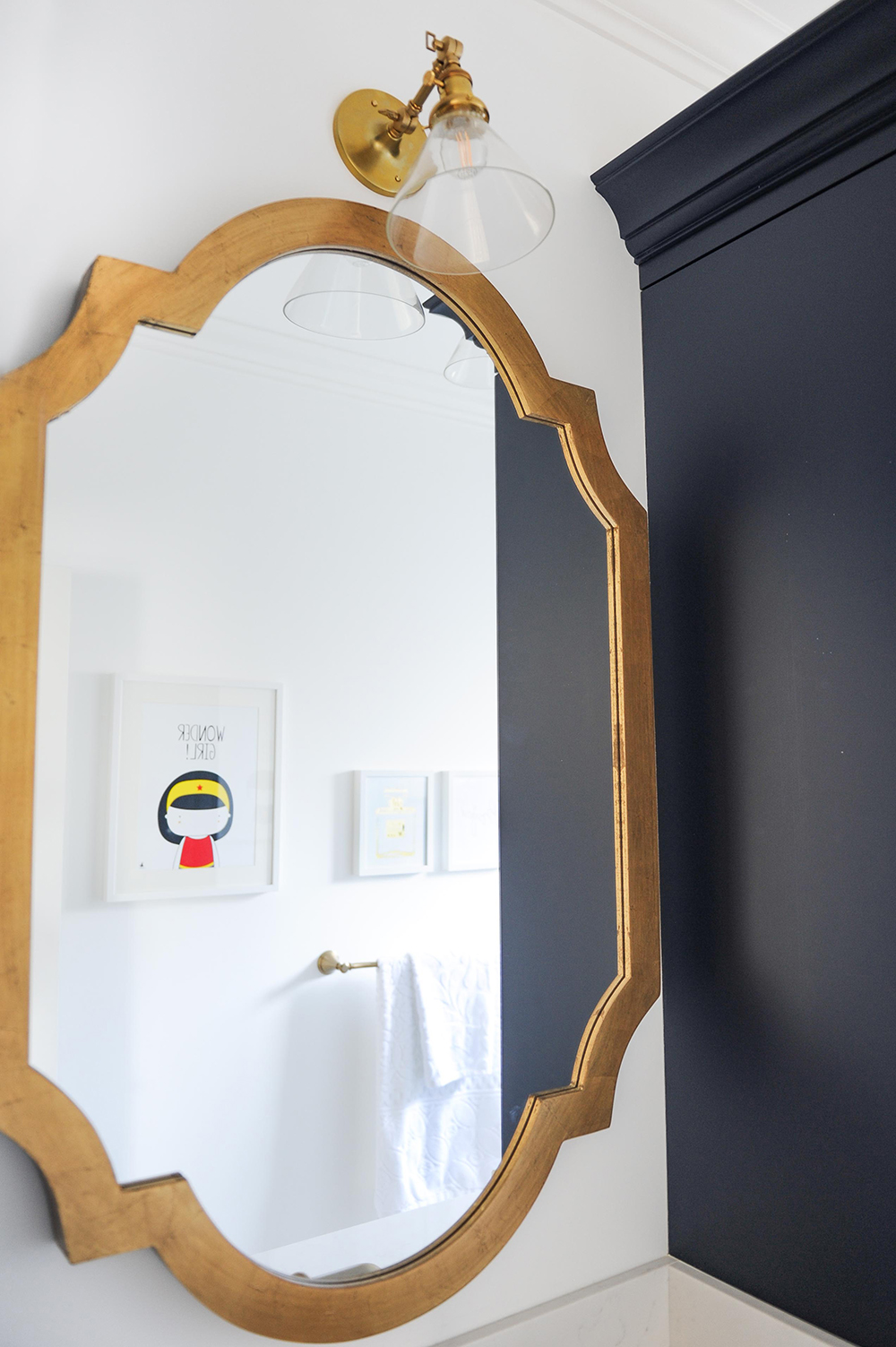This gold-framed mirror is a welcome departure from the expected flat mirror panel.