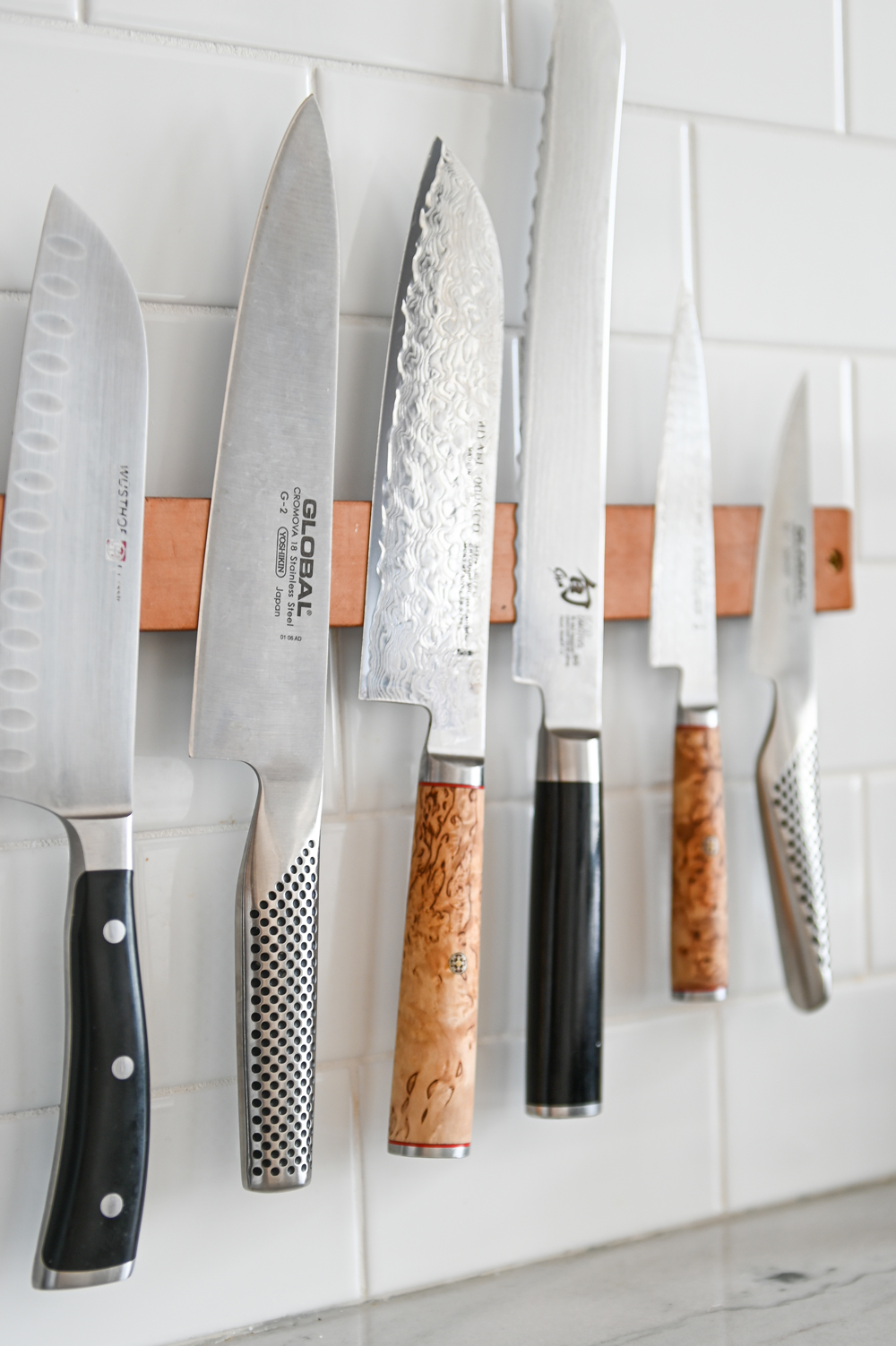 close up of kitchen knives on metallic holder