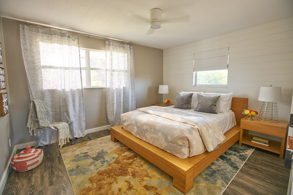 Bedroom with wood paneling painted white