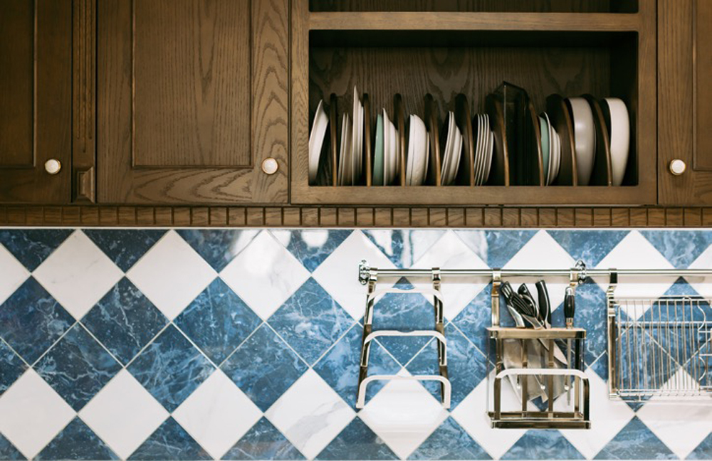 Brown kitchen cabinets with blue and white tile