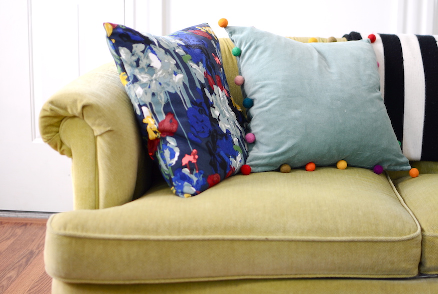 Velvet couch with colourful cushions