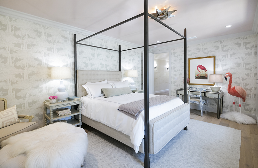 A neutral-tone bedroom with a 4 poster bed.