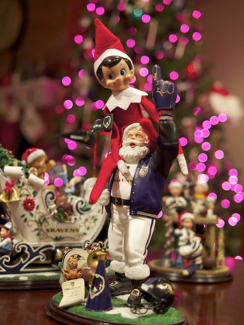 Elf on the shelf on santa's shoulder