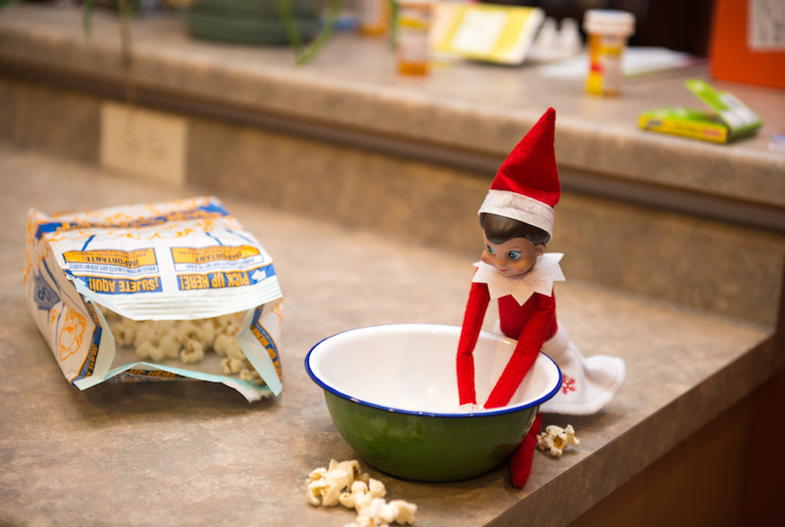 Elf on the Shelf eating popcorn out of bowl