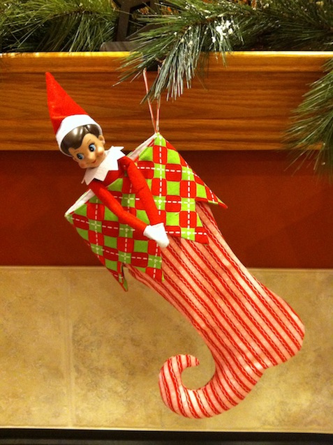Elf on the Shelf tucked into a Christmas stocking