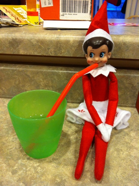Elf on the Shelf sipping from a straw