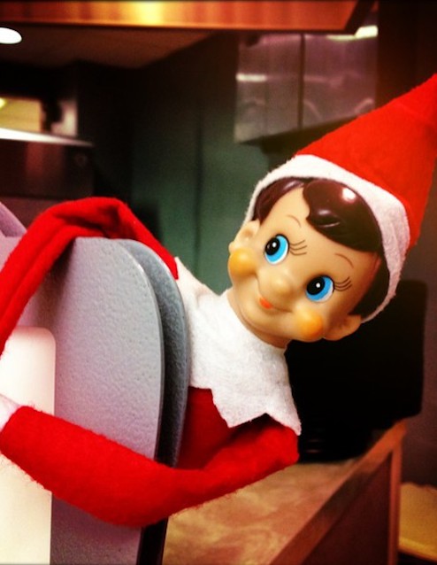 Elf on the shelf popping out on shelf