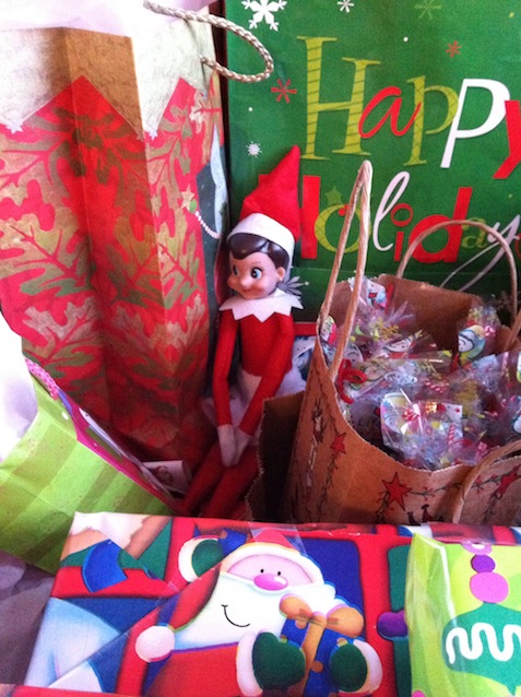 Elf on the Shelf tucked into Christmas presents