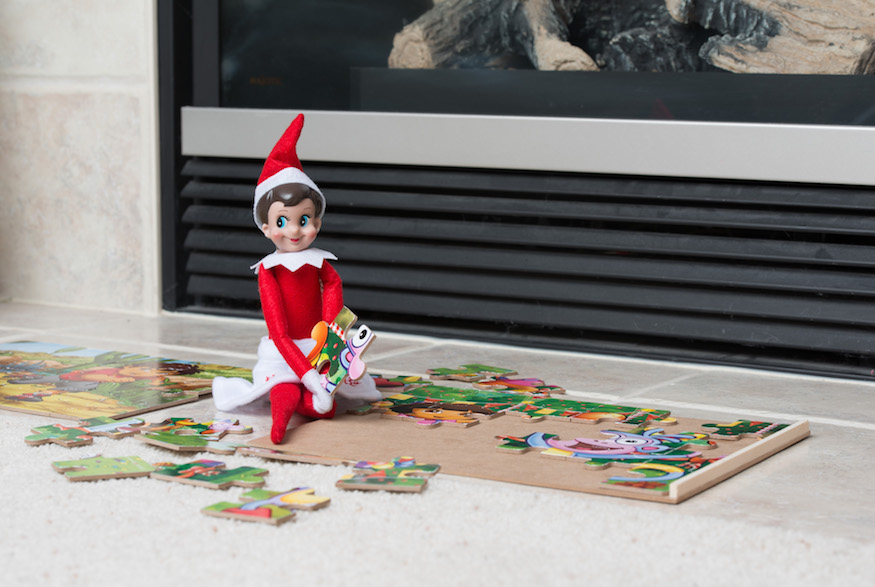 Elf on the Shelf Doing a Puzzle