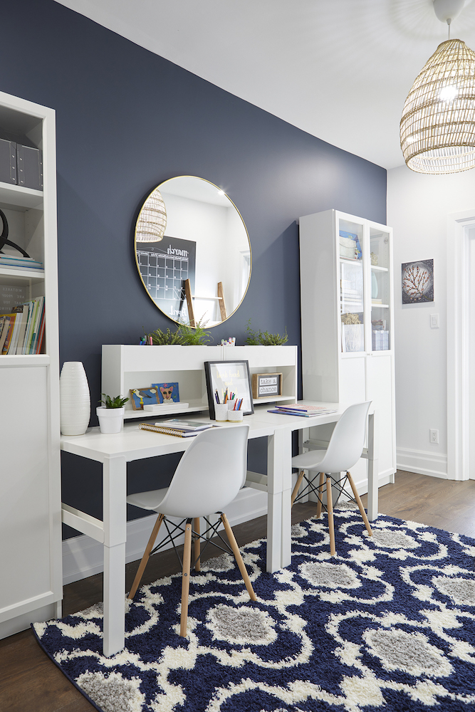 navy blue homework space with white desks and a patterned rug