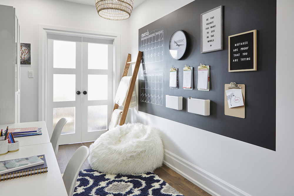 white homework room with black accent wall and ladder and frosted French doors