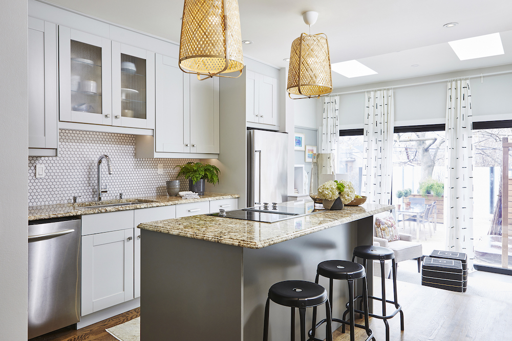 modern white kitchen with grey centre island and woven pendant lights