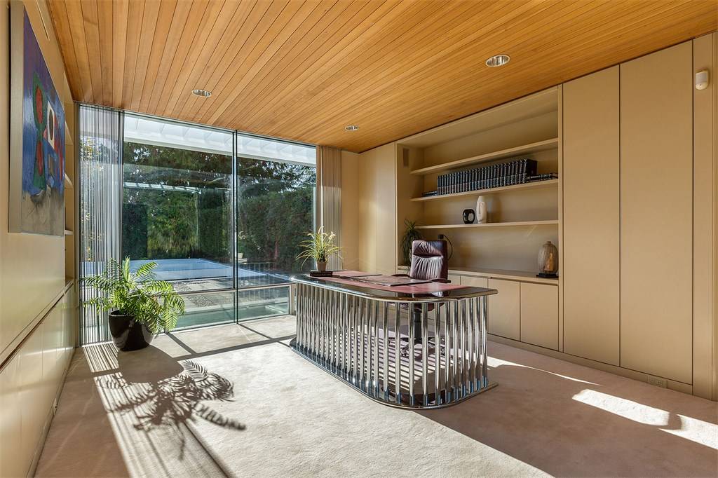 The neutral palette with hemlock ceilings found in the home office is meant to evoke a forest canopy