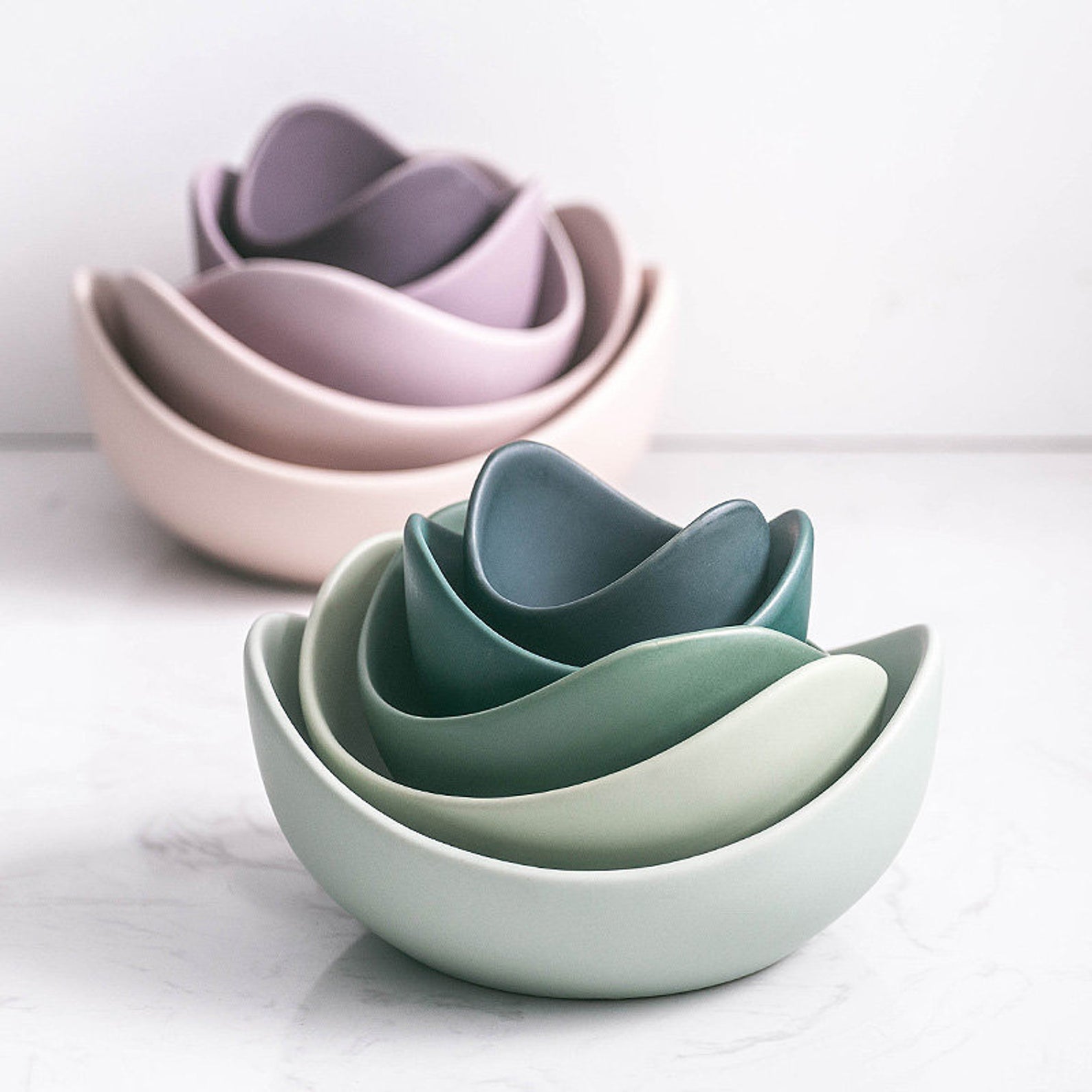 Sets of matte purple and teal nesting bowls