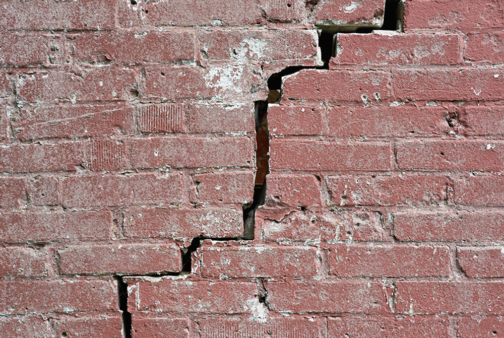 cracked red-brick wall