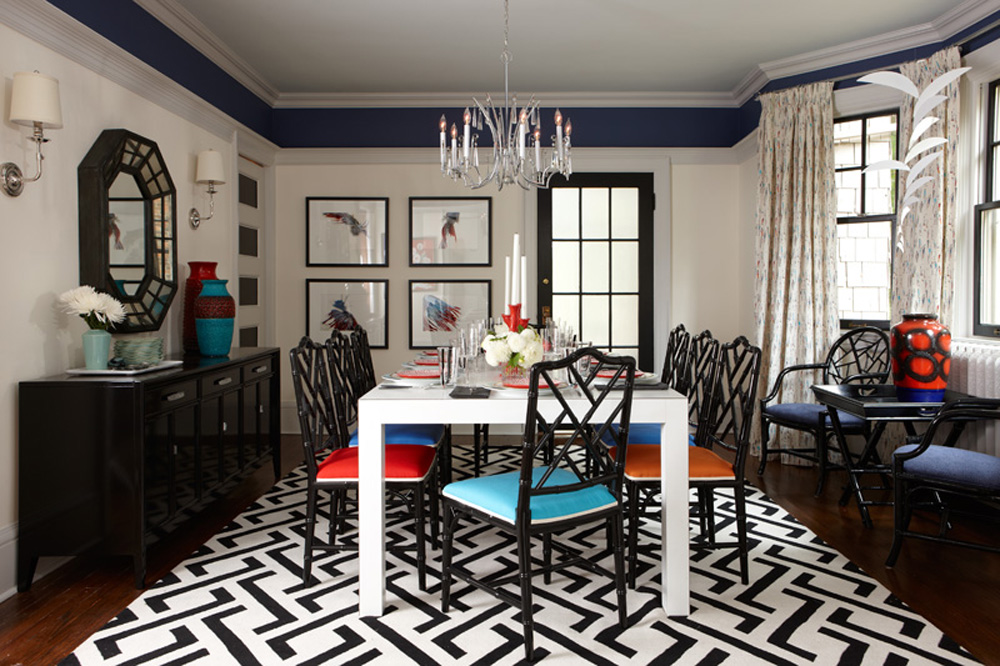 A boldly decorated dining room with a monochromatic theme with pops of colour.