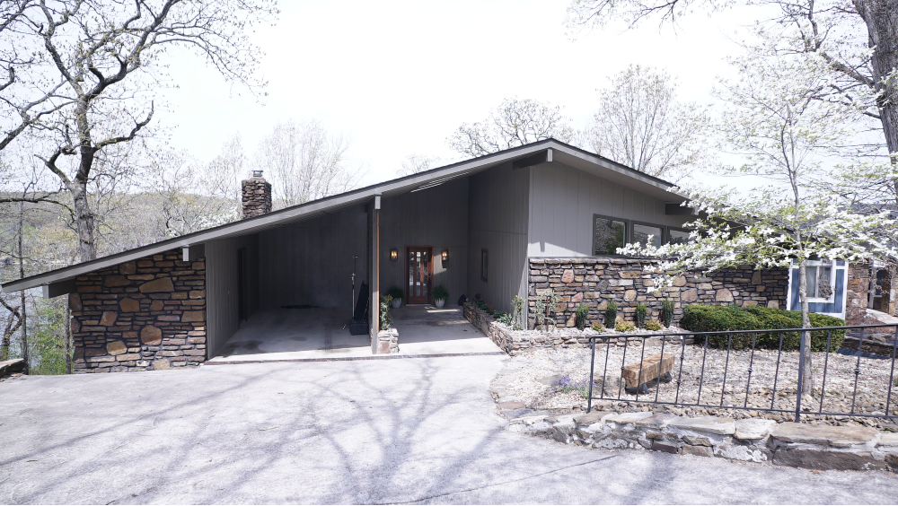 grey exterior of lake house with stone accent