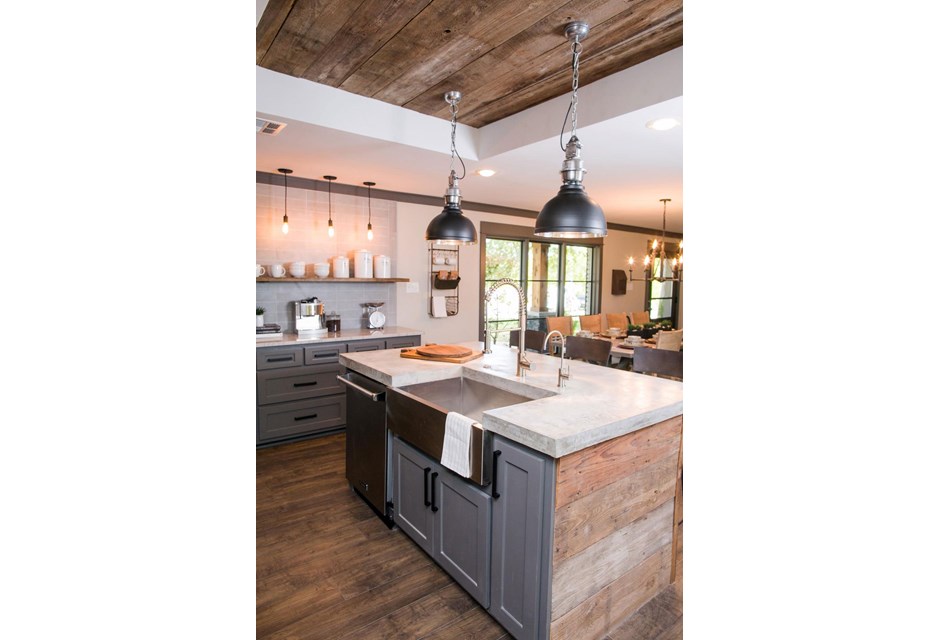 This barnyard ceiling ties in beautifully with the island and floors, but is broken up with soft greys and a rich trim. A gorgeous farm house sink and modern appliances complete the look.