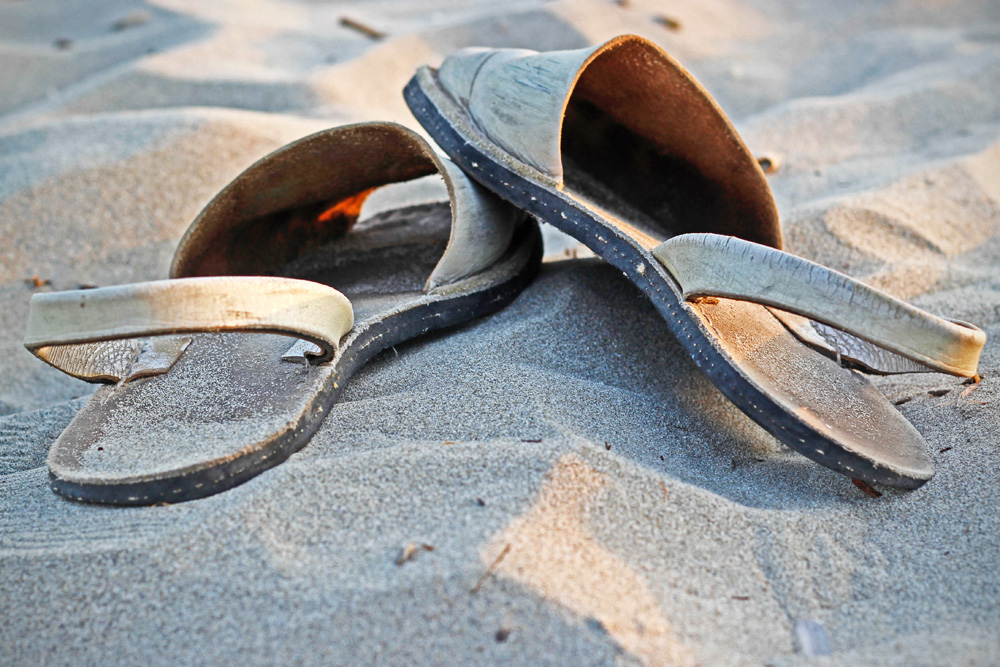 Old flip-flops on the beach