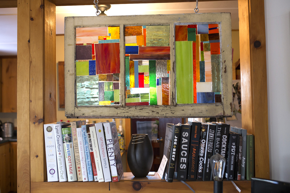 Stain-glassed frame with books underneath
