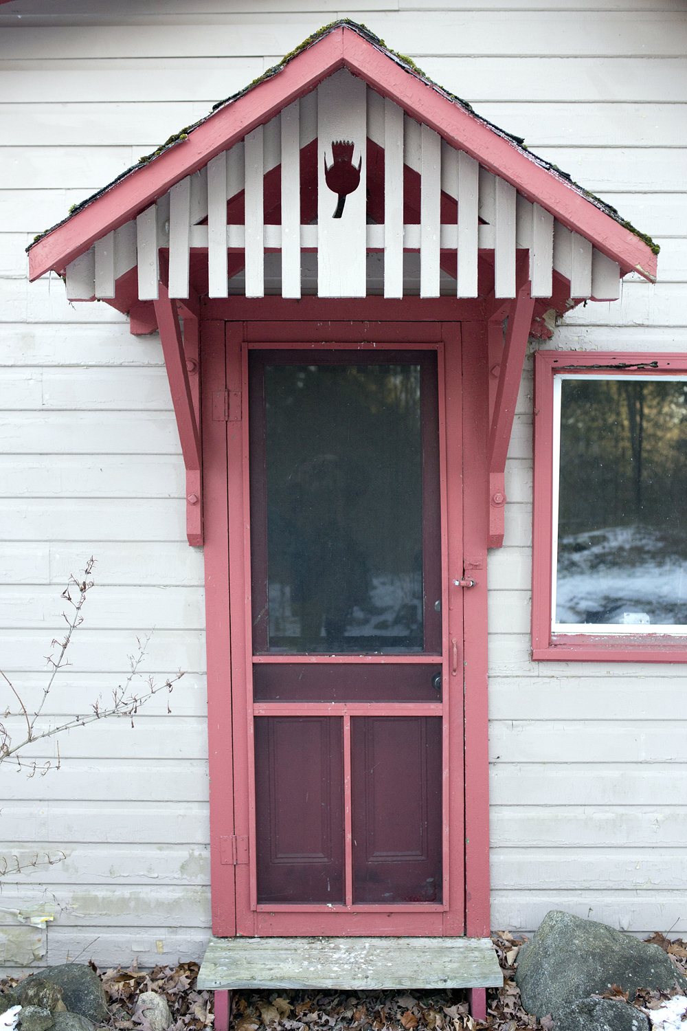 Red door on front of small storage space/guest cabin
