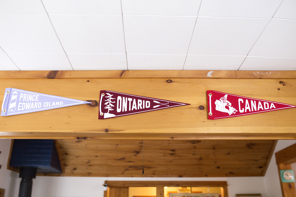 Province signs hanging on wood rafter