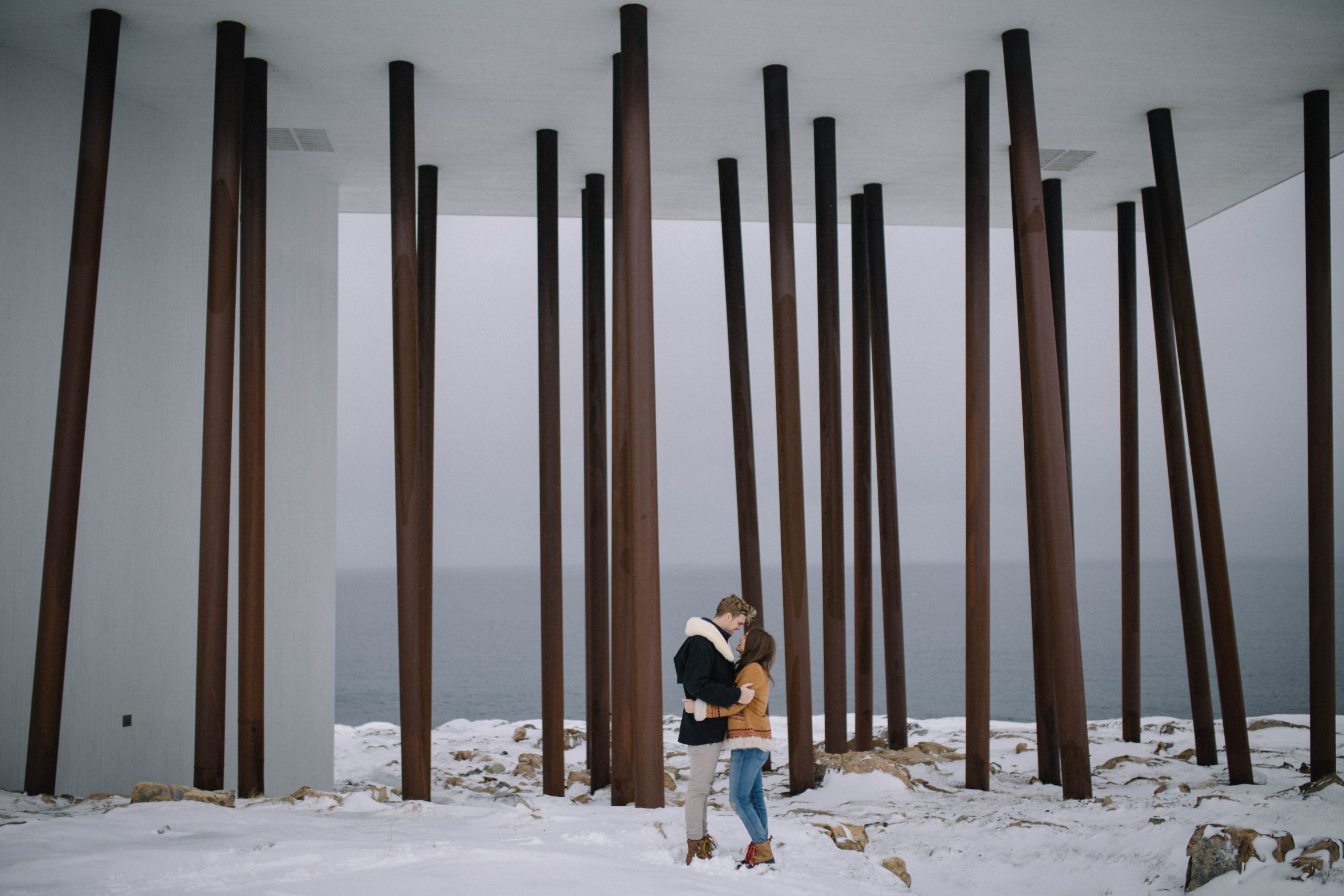 Couple hugging in front of Fogo Island Inn