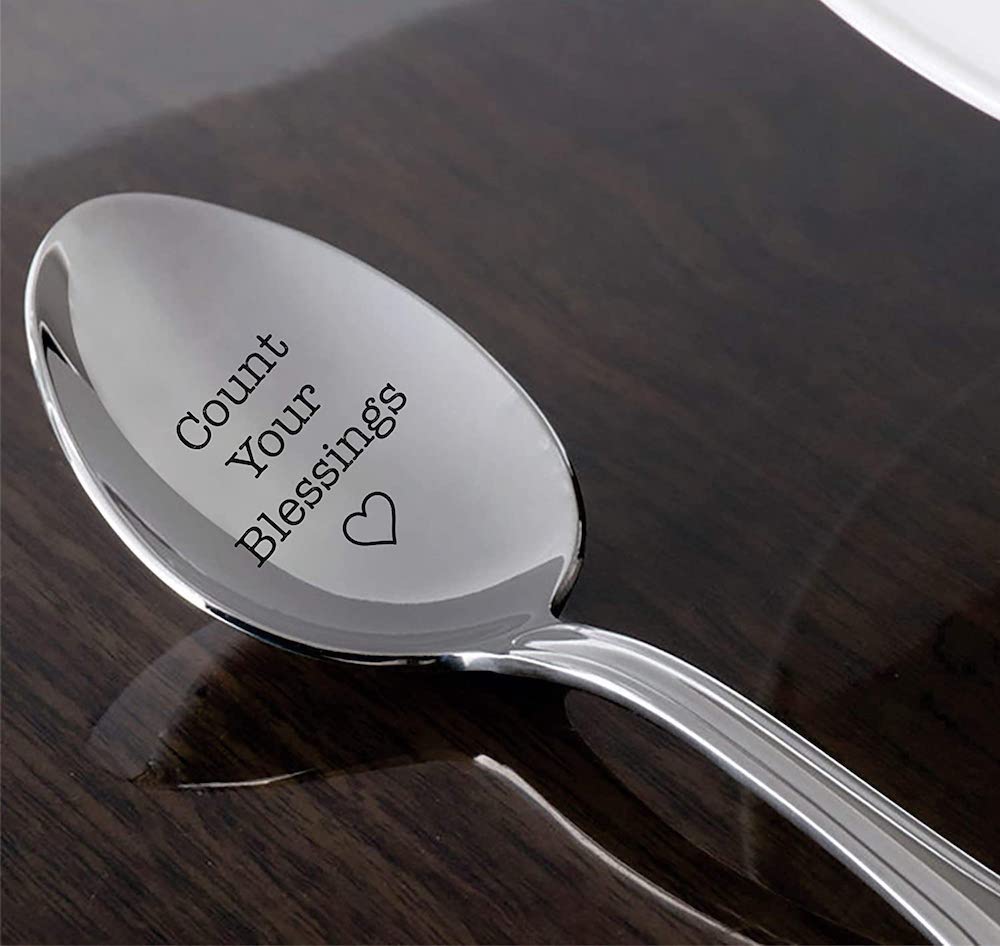 A serving spoon with an engraved saying