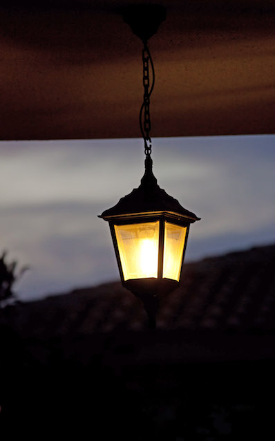 Hanging light fixture on front porch of home
