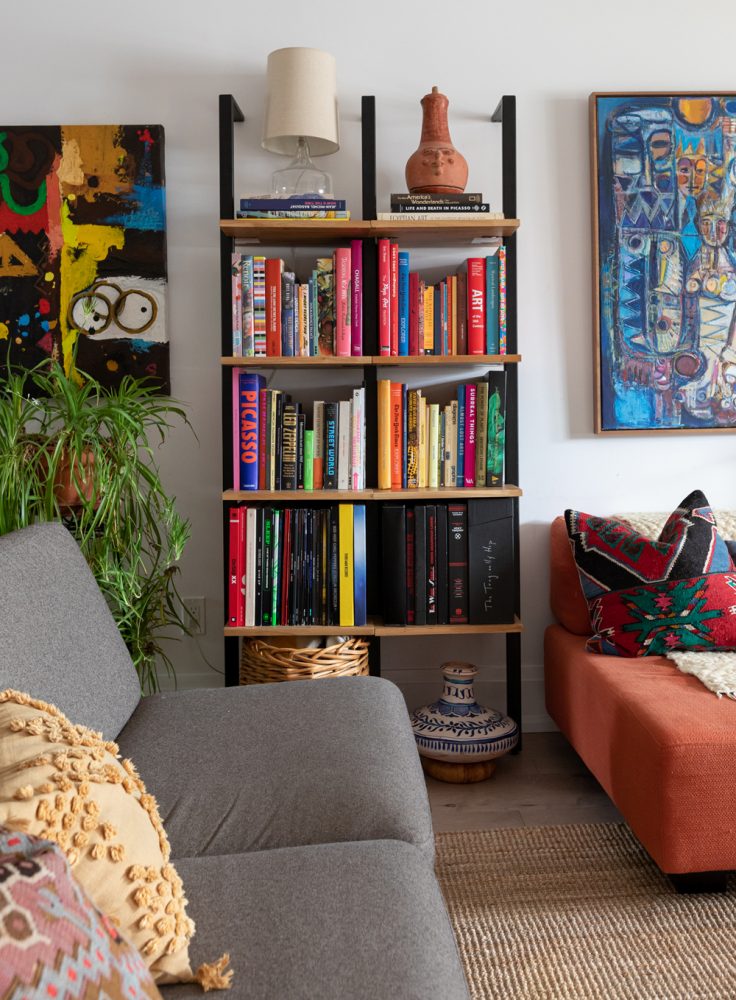 White living room with ladder shelving and colourful art books