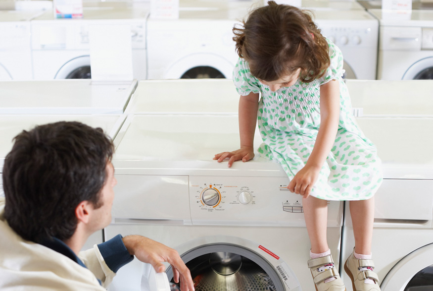 Father and daughter look at appliances