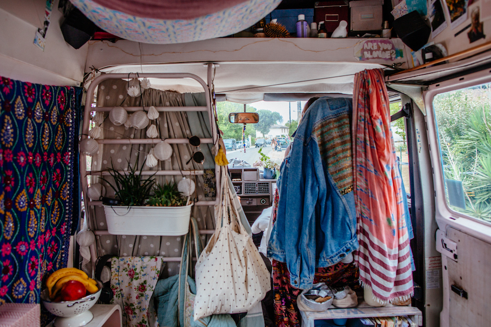 interior of camper van with colourful printed fabrics on walls and ceiling