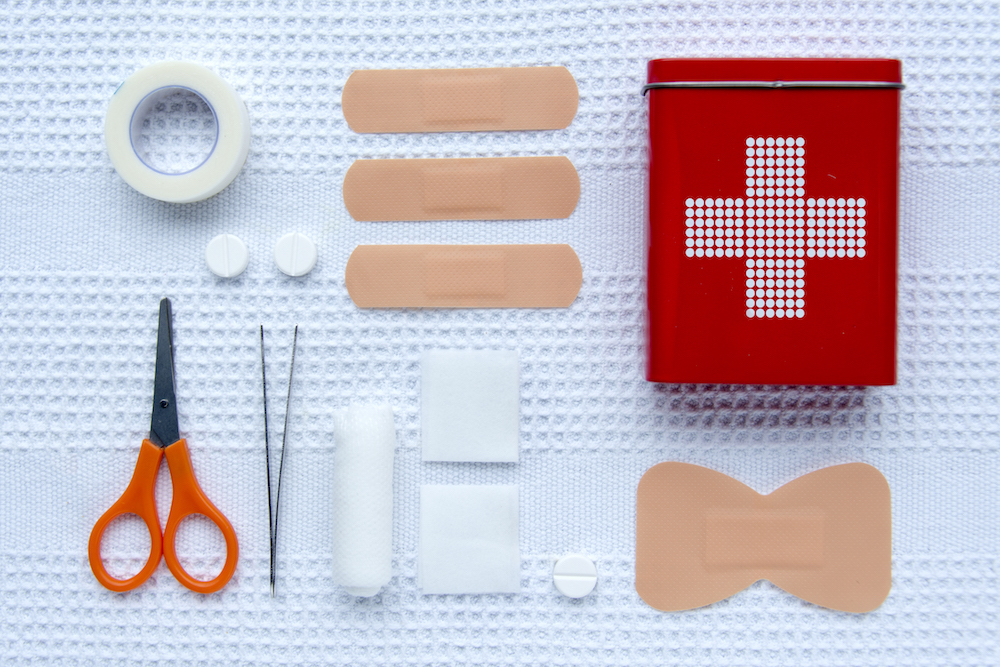 first aid supplies on white cloth