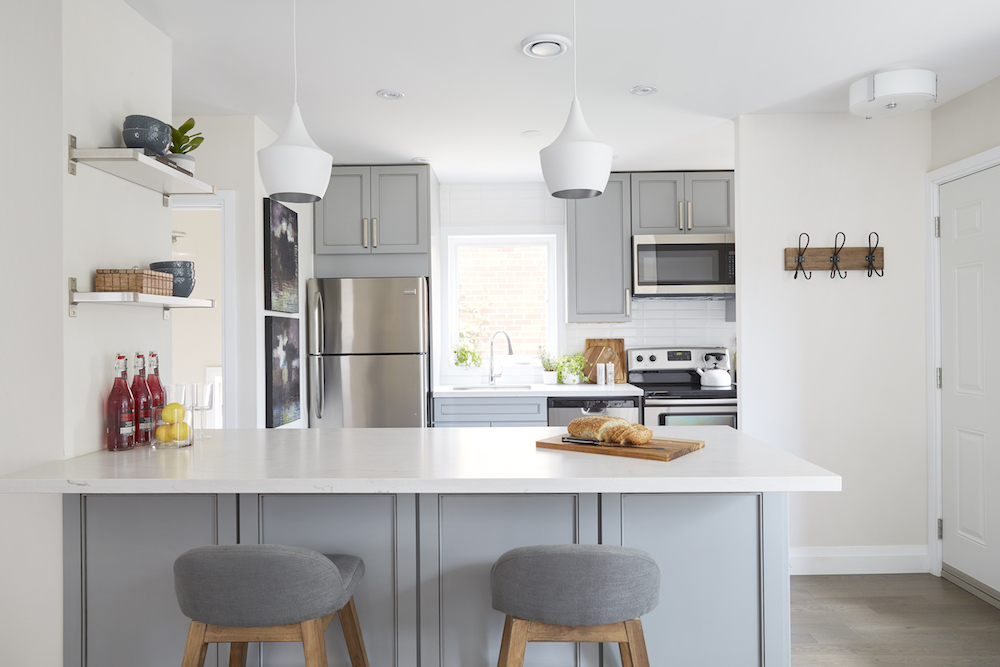 Modern grey kitchen with lots of white balance, lending a lighthearted appeal