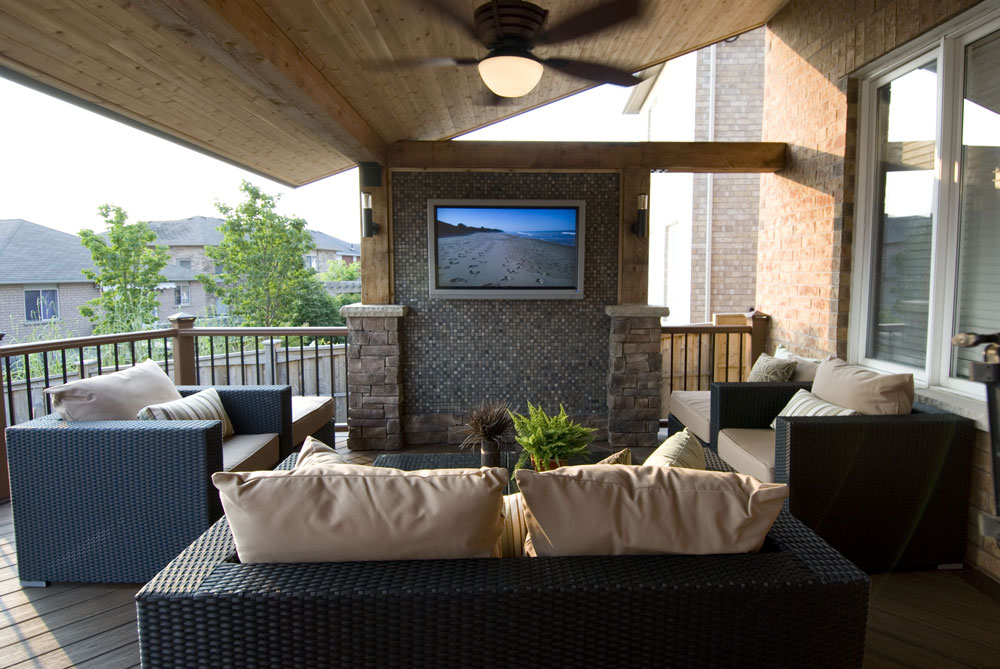 patio with black wicker couches and television