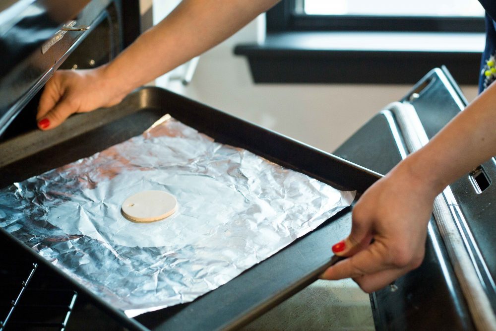 Place clay pieces on an oven-proof glass dish or metal tray and follow the baking instructions on the package