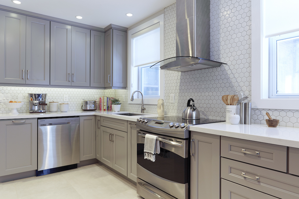 grey kitchen with white tile backsplash