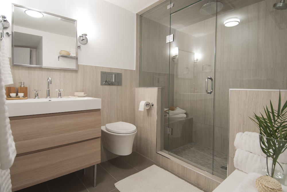 contemporary wood-walled bathroom with tankless white toilet