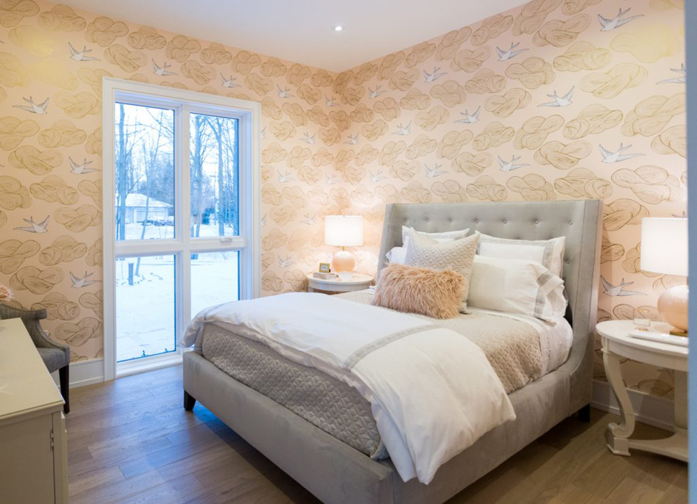 pillows on a white bed in a wallpapered bedroom
