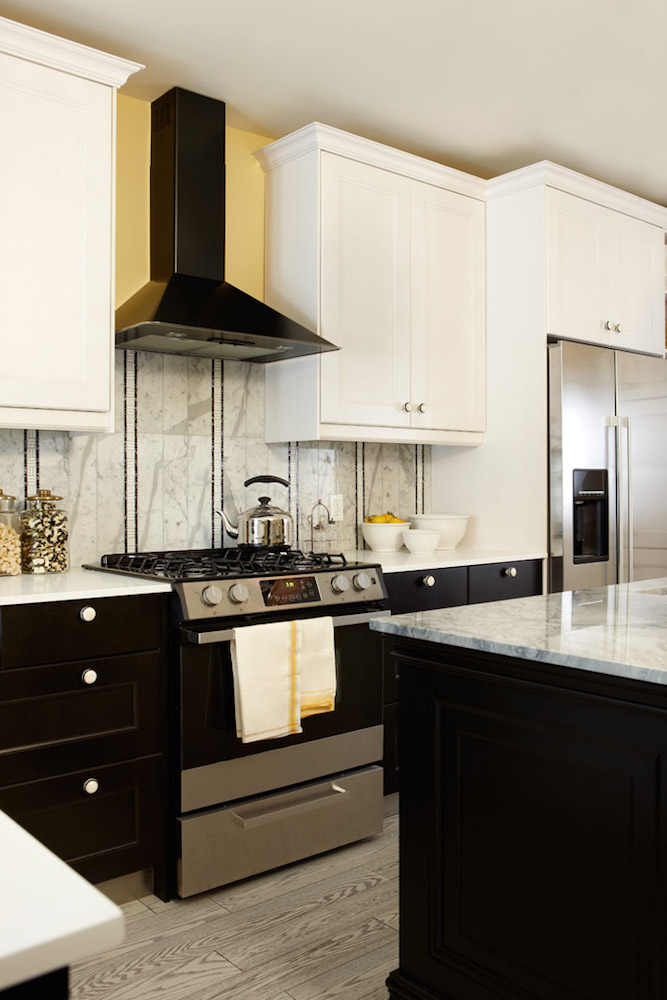 kitchen with white upper cabines and black lower cabinets