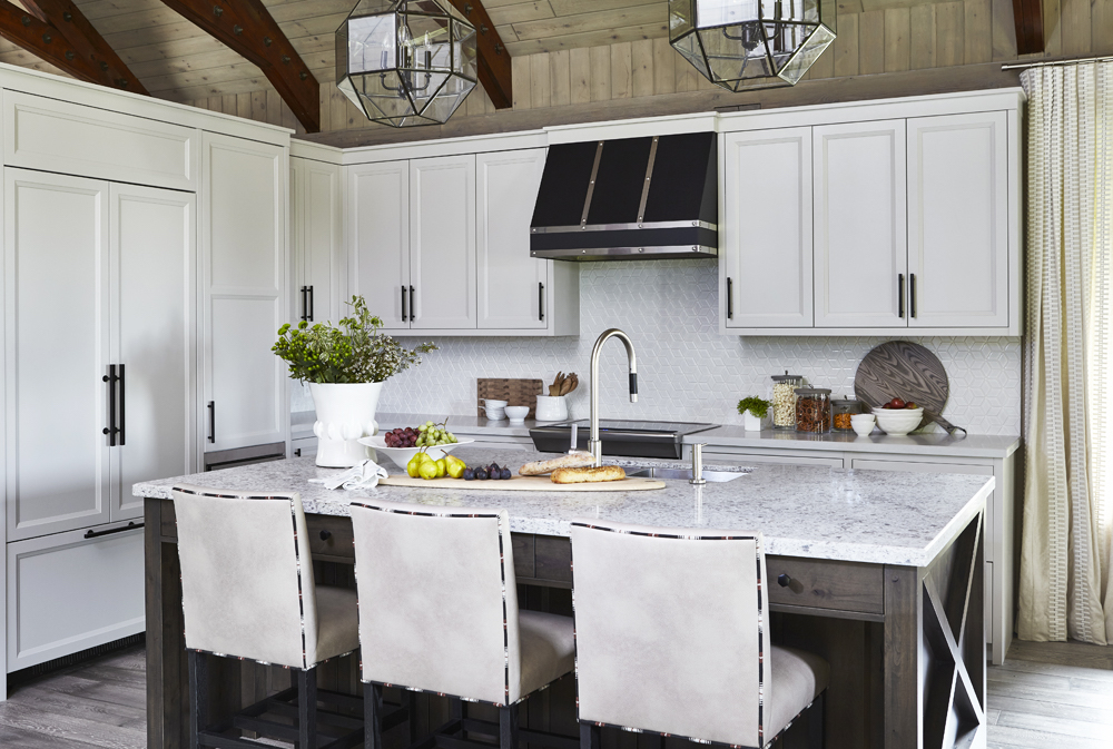 white cabinets with black hardware in modern kitchen with centre island