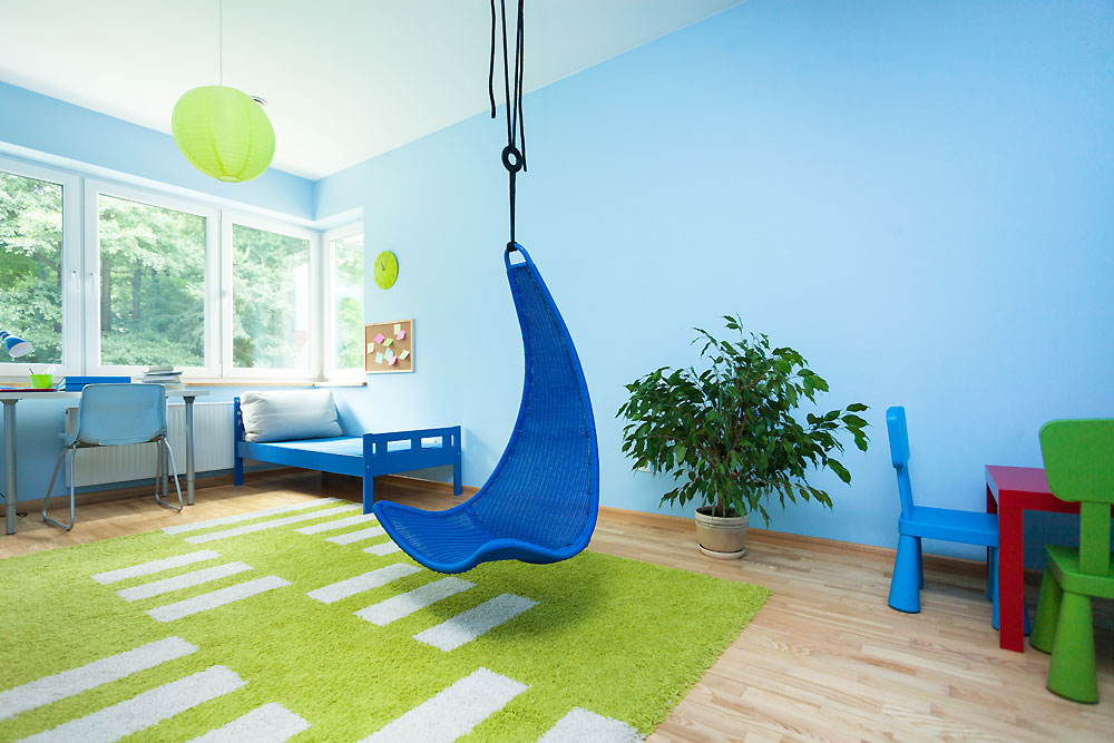 blue hanging chair in bright kids room